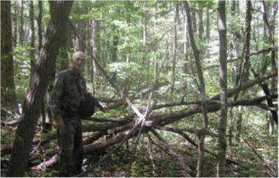 Dr. Burtsev next to structure allegedly built by Tennessee Bigfoot